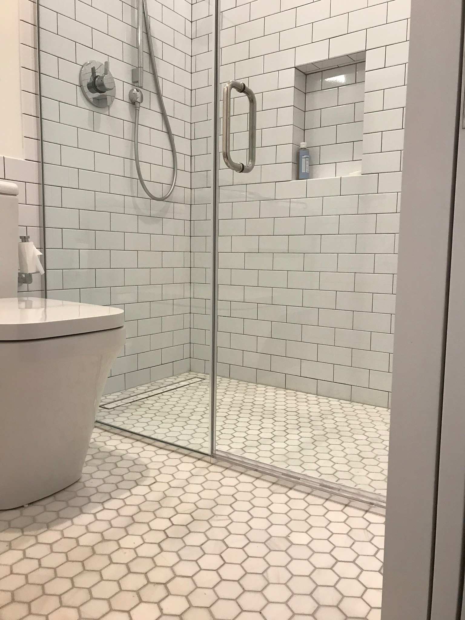Finished tile shower in a remodeled bathroom